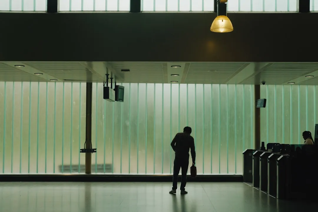 Man with bag walking in modern transit station